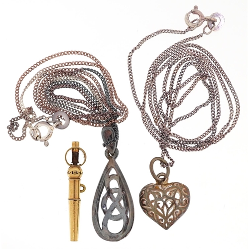 3309 - Two silver pendants on silver necklaces and an antique yellow metal watch key, total weight 7.0g.