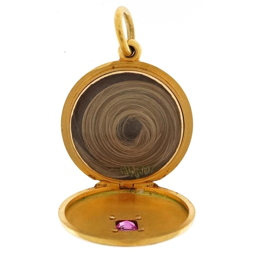 3017 - An unmarked gold ruby and diamond mourning locket housing a lock of hair, tests as 9ct gold, 21mm in... 