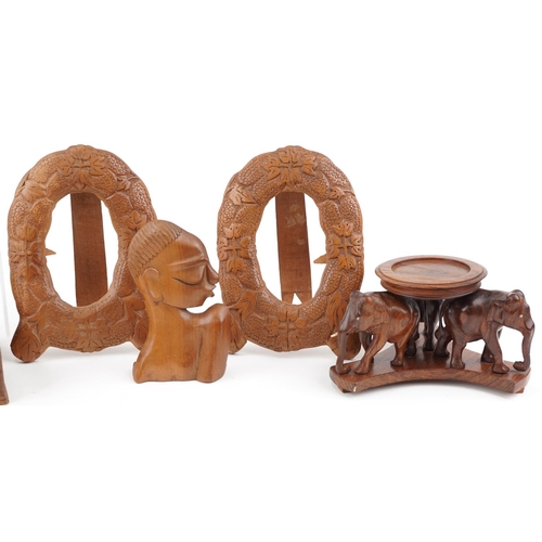 1518 - A group of late 20th century Indian carved softwood items including a pair of oval frames, a cigar b... 