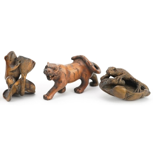 105 - Five Japanese carved wood netsukes including a lizard on a leaf, frog and Bulldog, the largest 6cm i... 