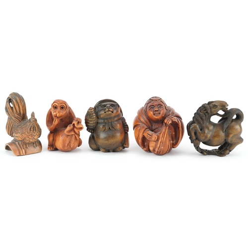 106 - Five Japanese carved wood netsukes including cockerel, horse and monkey with fruit, the largest 5cm ... 