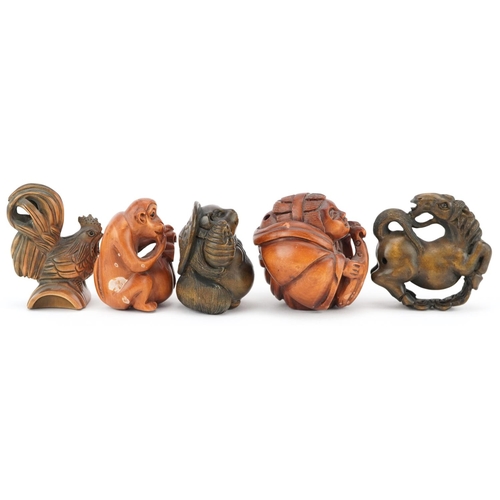 106 - Five Japanese carved wood netsukes including cockerel, horse and monkey with fruit, the largest 5cm ... 