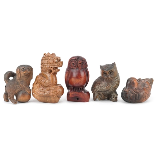 108 - Five Japanese carved wood netsukes including duck, dragon and owls, the largest 6cm high.