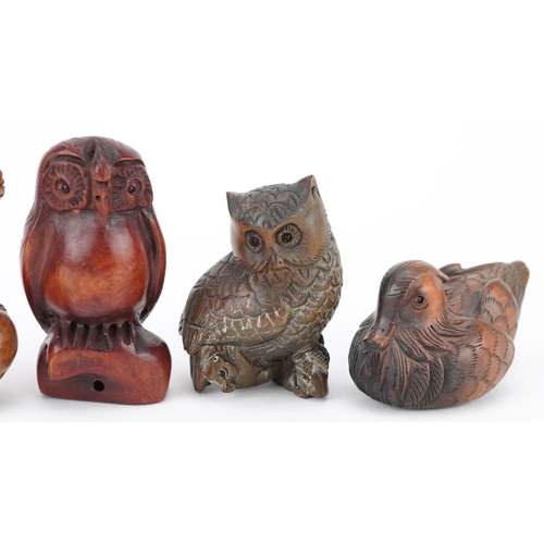 108 - Five Japanese carved wood netsukes including duck, dragon and owls, the largest 6cm high.