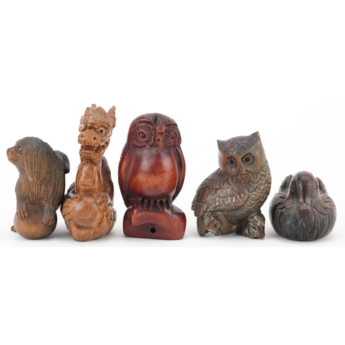 108 - Five Japanese carved wood netsukes including duck, dragon and owls, the largest 6cm high.