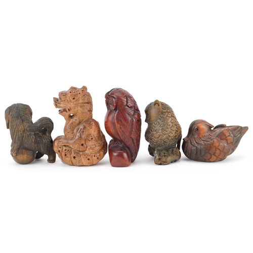 108 - Five Japanese carved wood netsukes including duck, dragon and owls, the largest 6cm high.