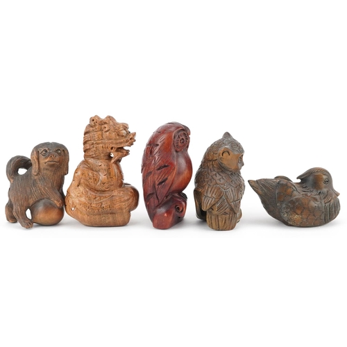 108 - Five Japanese carved wood netsukes including duck, dragon and owls, the largest 6cm high.