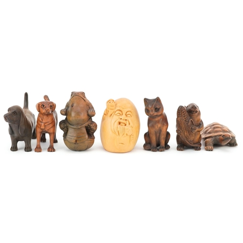 110 - Seven Japanese carved wood netsukes including mouse with corn, tortoise, toad and dogs, the largest ... 