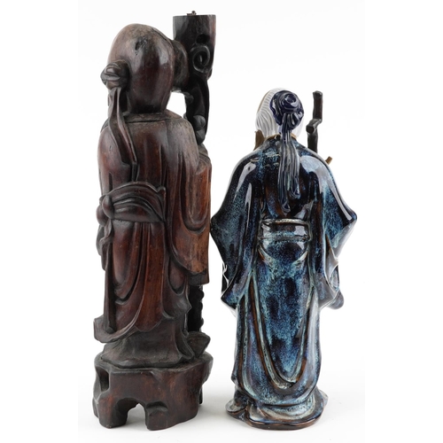 1516 - A large Chinese carved wood figure of an elder with staff and fruit together with a Mud Man example,... 