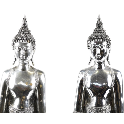 1459 - A large pair of silvered figures of standing Tibetan Buddha, 65cm high.