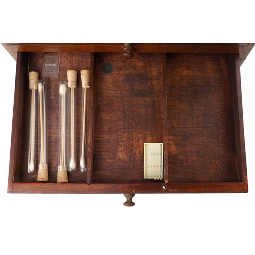 140 - A Victorian mahogany dentist's box, the hinged lid revealing a compartmentalized interior above six ... 