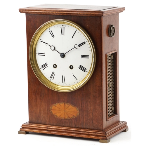  An Edwardian mahogany mantle clock with inlaid decoration, the white enamelled circular dial with Ro... 