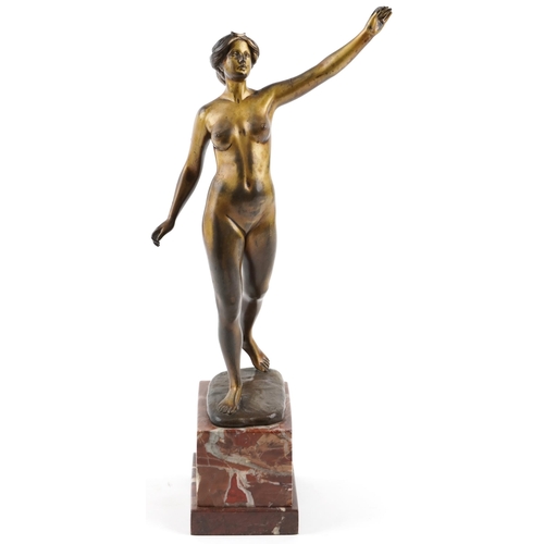  An Art Deco bronze figure of a standing female nude by Otto Scheer, raised on a rouge marble plinth ... 