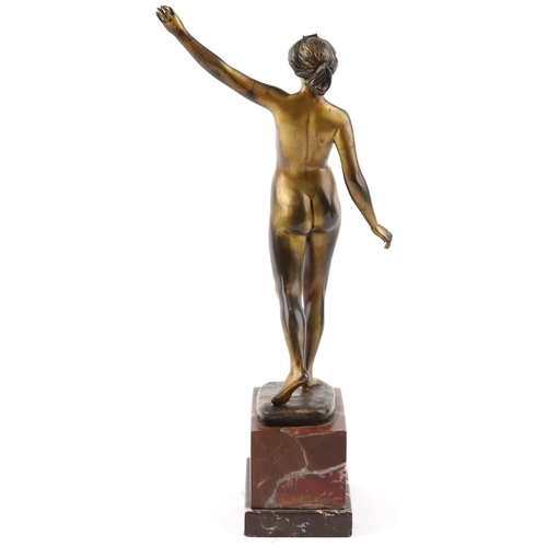  An Art Deco bronze figure of a standing female nude by Otto Scheer, raised on a rouge marble plinth ... 