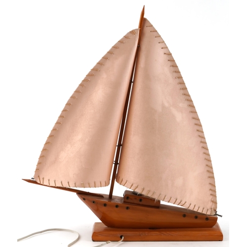 1514 - A mid century teak table lamp in the form of a sailing boat, 53cm high.