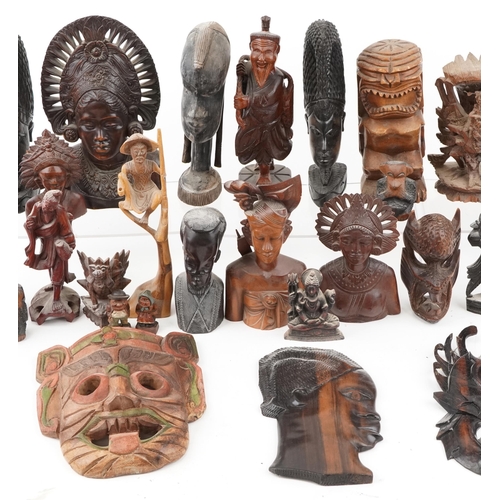 1471 - A large collection of Middle Eastern carved wood figures and wall masks including Malaysian busts, A... 