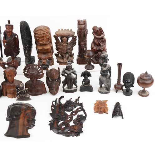 1471 - A large collection of Middle Eastern carved wood figures and wall masks including Malaysian busts, A... 