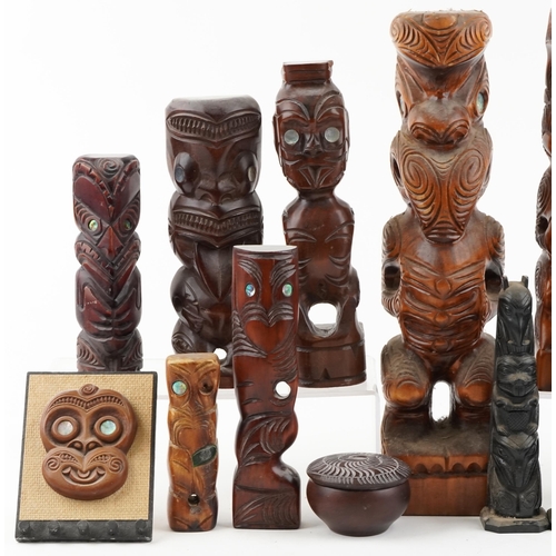 329 - A collection of New Zealand Māori carved figures and Canadian carved slate tribal poles, the largest... 