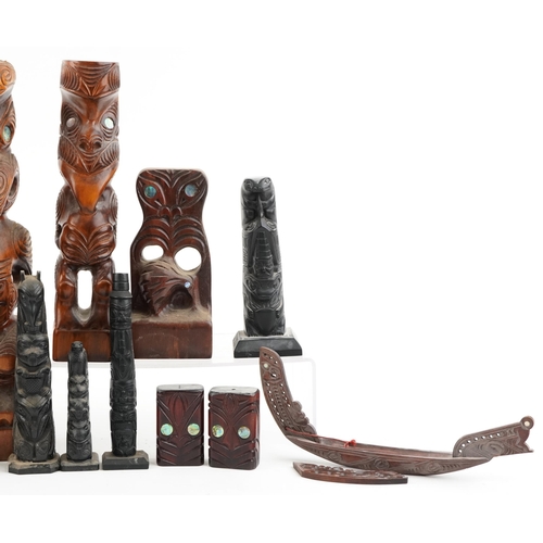 329 - A collection of New Zealand Māori carved figures and Canadian carved slate tribal poles, the largest... 