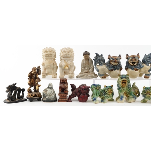 1505 - A collection of Chinese figures including pottery Foo dogs, carved stone Foo dogs and Mud Men, the l... 