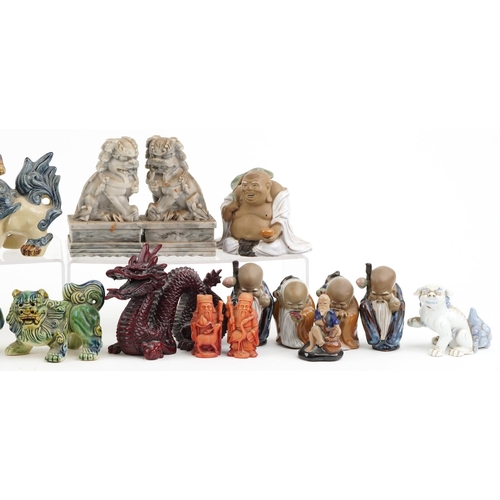 1505 - A collection of Chinese figures including pottery Foo dogs, carved stone Foo dogs and Mud Men, the l... 