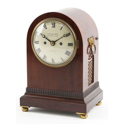 A 19th century figured mahogany mantle clock with eight day movement striking on a gong, the circular white enamelled dial with black Roman numerals, inscribed John Bennett, 65 Cheapside, London, 32cm with a pendulum and key.