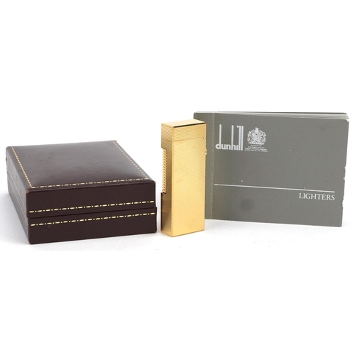 74 - A Dunhill gold plated gas lighter with engine turned decoration, boxed.