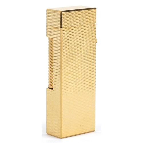 74 - A Dunhill gold plated gas lighter with engine turned decoration, boxed.