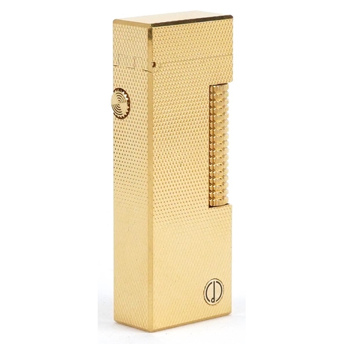 74 - A Dunhill gold plated gas lighter with engine turned decoration, boxed.