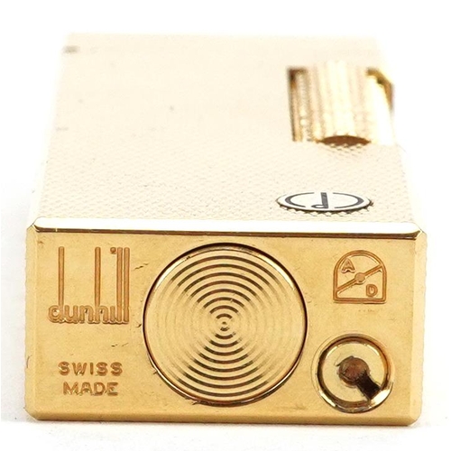 74 - A Dunhill gold plated gas lighter with engine turned decoration, boxed.