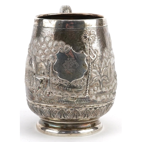 408 - A Middle Eastern silver tankard profusely embossed with farmers and buildings, 9.5cm high, 163.0g