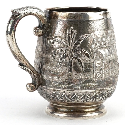 408 - A Middle Eastern silver tankard profusely embossed with farmers and buildings, 9.5cm high, 163.0g