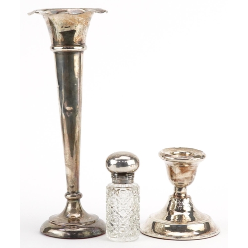 432 - Silver objects comprising a bud vase, candlestick and cut glass scent bottle with a silver lid, the ... 