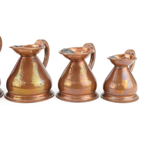 130 - A graduated set of five late 19th century copper measuring jugs, largest H-13cm