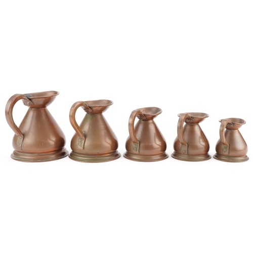 130 - A graduated set of five late 19th century copper measuring jugs, largest H-13cm