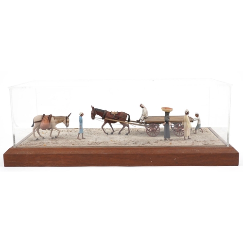 331 - A late 20th century scratch built 1:25 scale diorama, figures and mules on a road, dated 1982 within... 