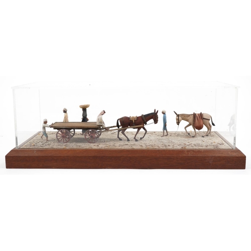 331 - A late 20th century scratch built 1:25 scale diorama, figures and mules on a road, dated 1982 within... 