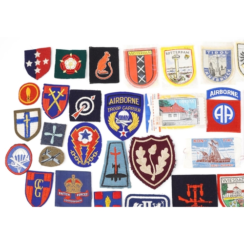 2467 - A group of various cloth badges to include some military British and European.