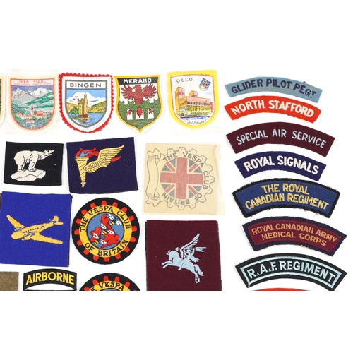 2467 - A group of various cloth badges to include some military British and European.