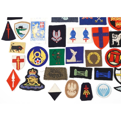 2467 - A group of various cloth badges to include some military British and European.