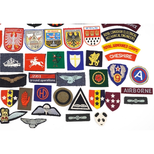 2467 - A group of various cloth badges to include some military British and European.