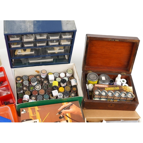 1544 - A collection of model making tools including two airbrush kits, various paint and other equipment.