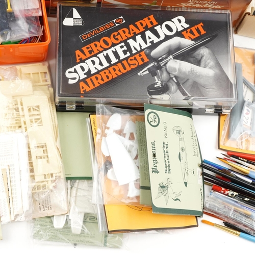 1544 - A collection of model making tools including two airbrush kits, various paint and other equipment.