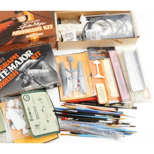 1544 - A collection of model making tools including two airbrush kits, various paint and other equipment.