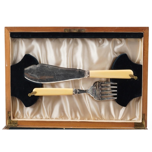 1164 - An Art Deco plated set of fish knives and forks, within a walnut case, W-35cm.