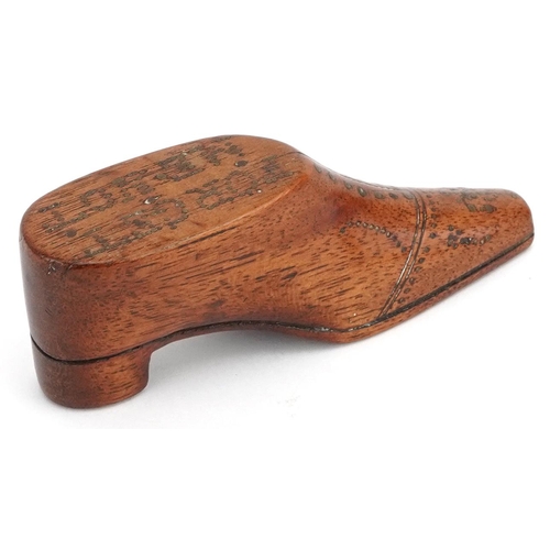 310 - A late 19th century treen forget-me-not carved model of a gentlemen's shoe, 11cm in length.