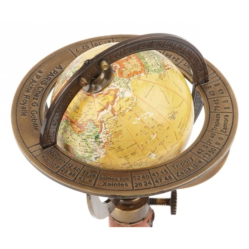 1364 - A diminutive brass rotating territorial table globe, 30cm high.