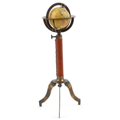 1364 - A diminutive brass rotating territorial table globe, 30cm high.