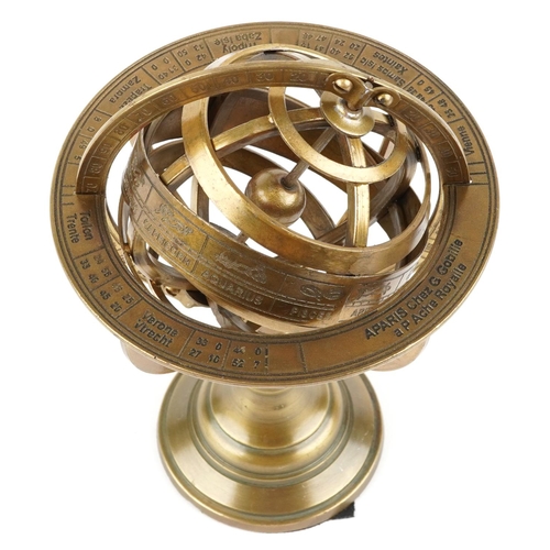 1441 - A brass rotating table compass decorated with zodiac signs, 20cm high.