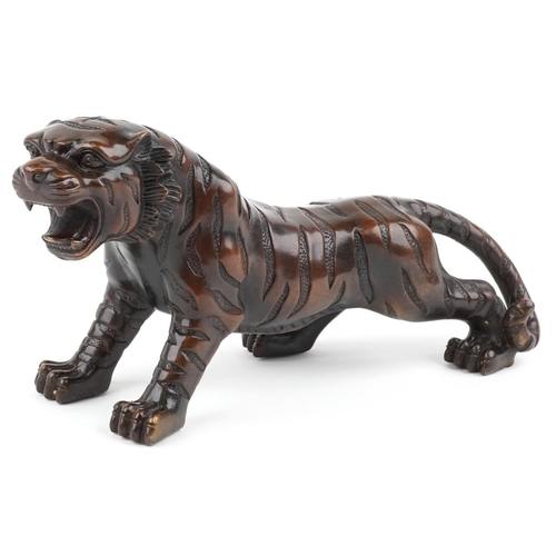 111 - A Japanese brown patinated bronze okimono figure of a tiger, 34cm in length.